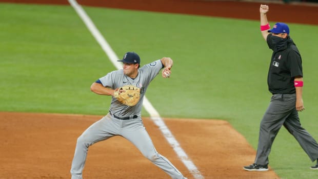 May 9, 2021; Arlington, Texas, USA; Seattle Mariners first baseman Evan White (12) starts a double play during the sixth inning against the Texas Rangers at Globe Life Field. Mandatory Credit: Andrew Dieb-USA TODAY Sports